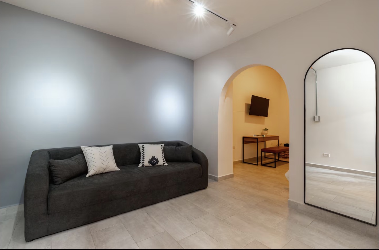 AL101 — living area with sofa and arched mirror